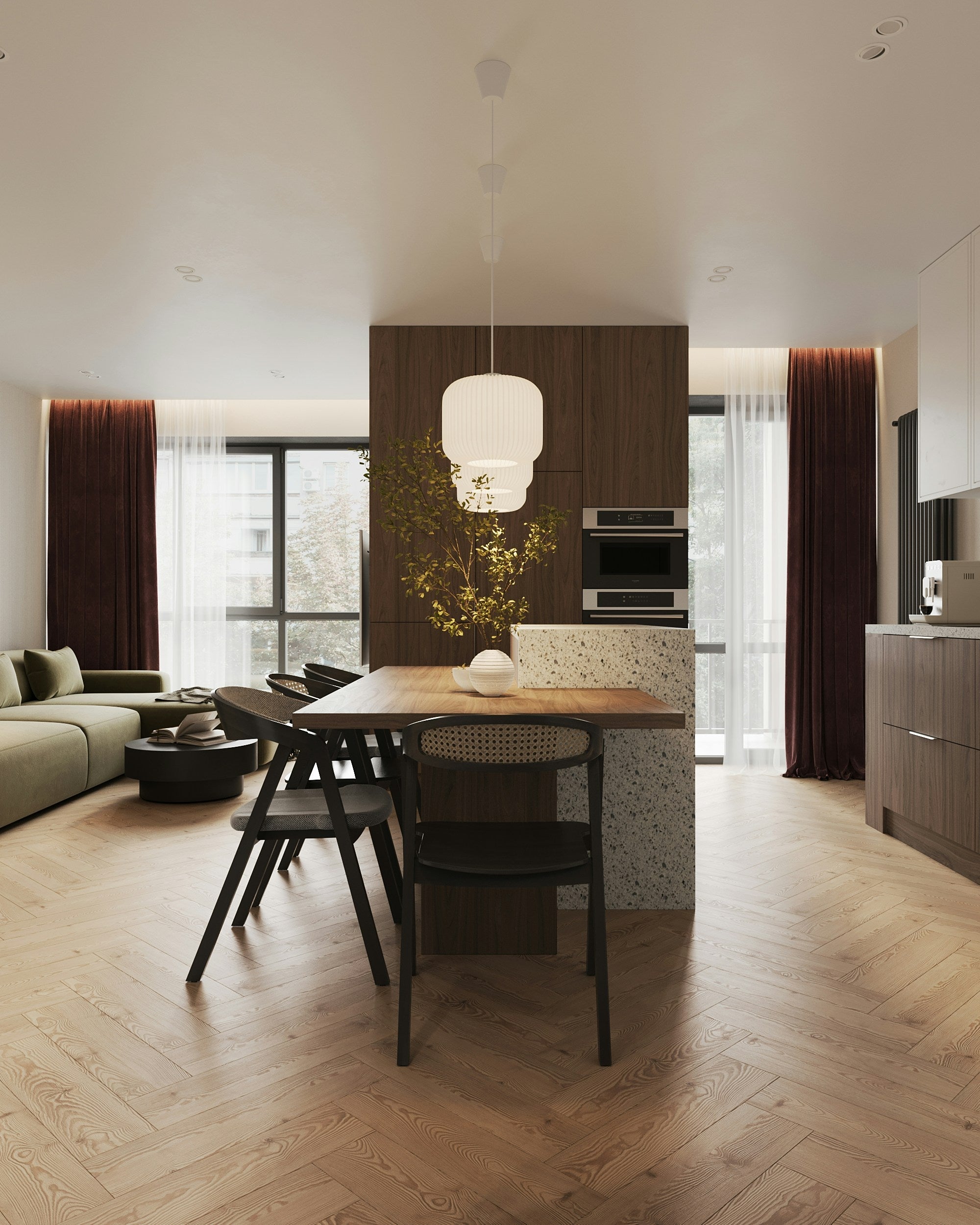Modern open-plan kitchen and dining area with wooden floors, a rectangular table with black chairs, pendant lights, and large windows with dark curtains.