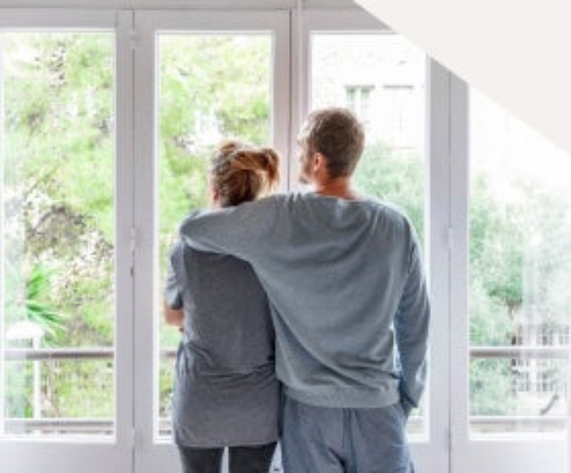A couple gazes out the window, sharing a moment of reflection and connection.